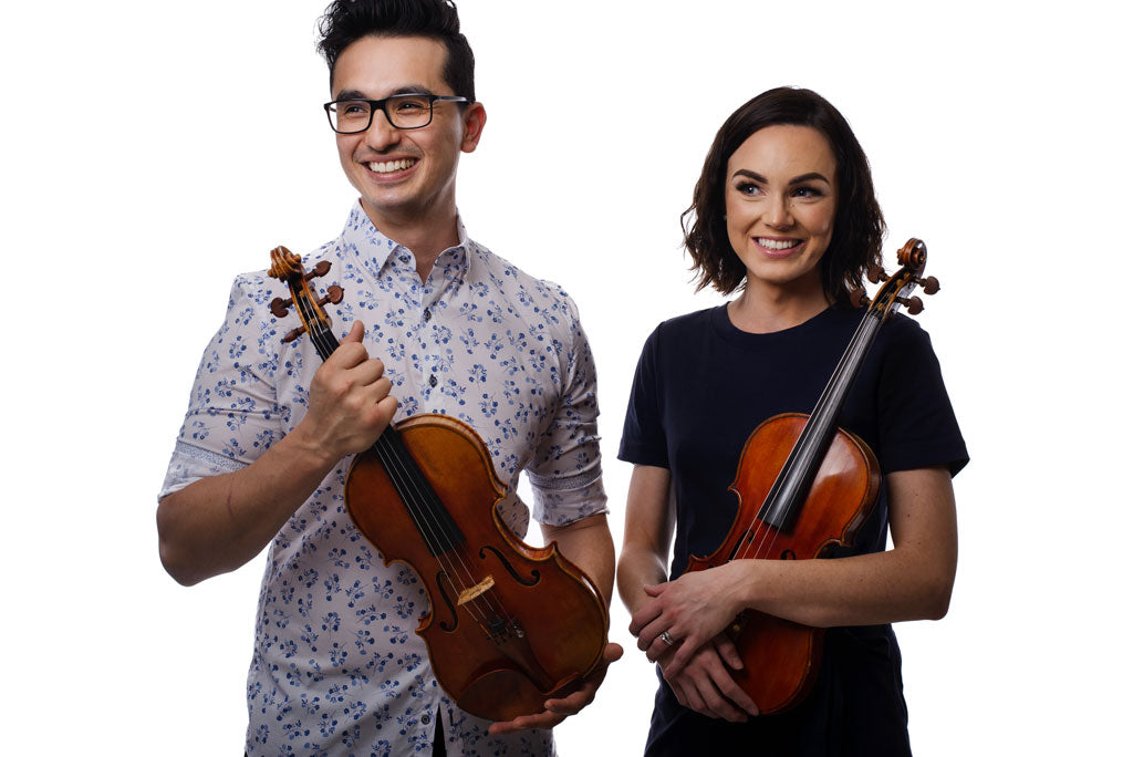 David Dalseno and Jenny Dalseno founders of First Strings holding their signature violins